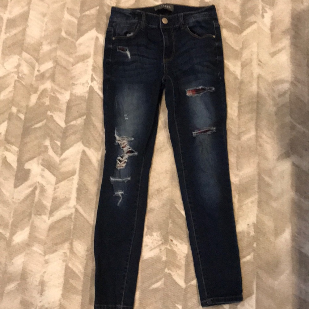 Dark wash jeans with plaid distressed detail